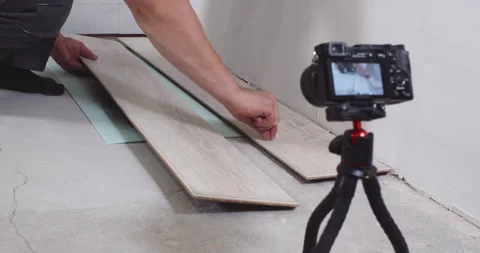 Construction worker showing laminate plank in front of camera Stock Footage 303710188