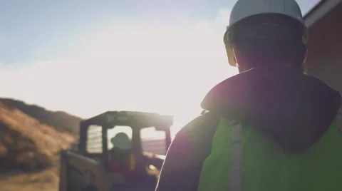 Construction worker signaling to machine operator Stock Footage 55164568