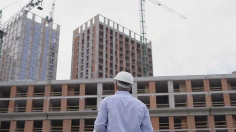 Construction Worker Signals to Crane Operator on Construction Site. 4K Stock Footage 111593205