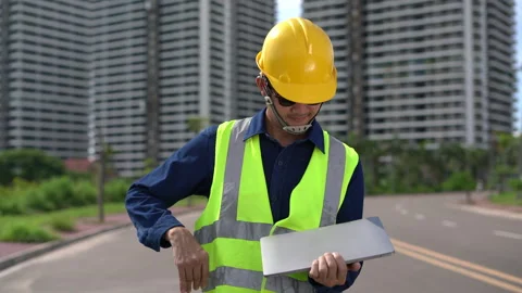 Construction Worker on Site: A focused construction worker wearing a safety.. Stock Footage 297598511