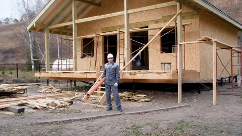 Construction worker on site juggle pipe. 4k slow motion 60 fps. Builder 스톡 동영상 96987628