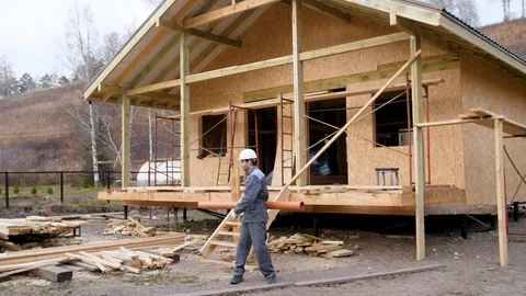 Construction worker on site juggle pipe. 4k slow motion 60 fps. Builder Stock Footage 96988529