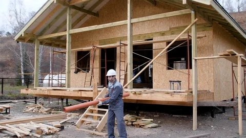 Construction worker on site juggle pipe. 4k slow motion 60 fps. Builder Stock Footage 96989352