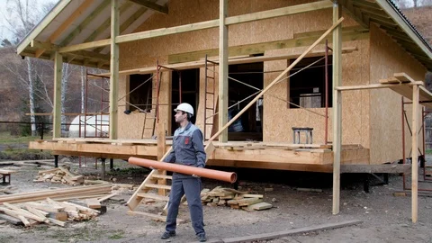 Construction worker on site juggle pipe. 4k slow motion 60 fps. Builder 動画素材 96989784