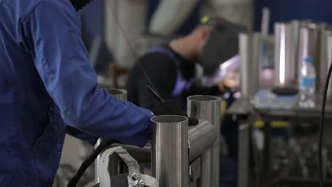 Construction worker at the site welding metal pipes with special blue helmet 스톡 동영상 142875539