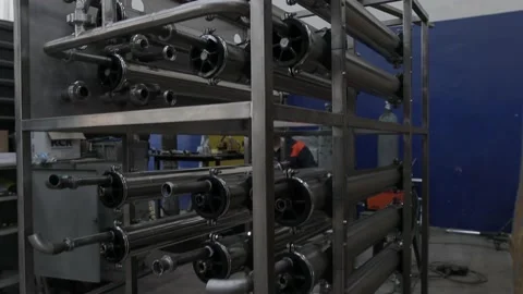 Construction worker at the site welding metal pipes with special blue helmet Vídeo Stock 142880324
