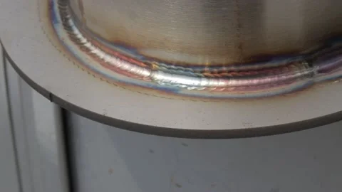 Construction worker at the site welding metal pipes with special blue helmet Vídeo Stock 142881852