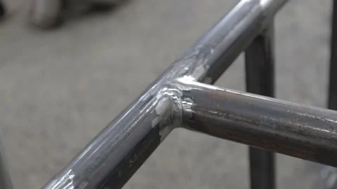 Construction worker at the site welding metal pipes with special blue helmet Stock Footage 142884531