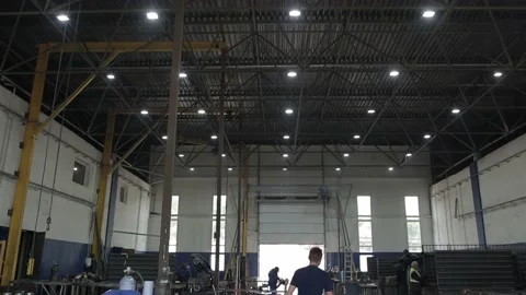Construction worker at the site welding metal pipes with special blue helmet Stock Footage 142888585