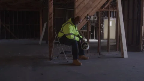 Construction Worker Sits In Unfinished Building Takes Off Hard Hat Video stock 270391309