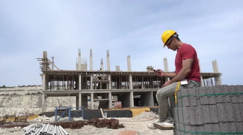 Construction Worker sitting and talking on phone.  Stock Footage 63053905