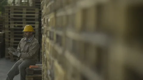 Construction worker sitting on pellets for a lunch break; Full HD Photo JPEG Stock Footage 40758302