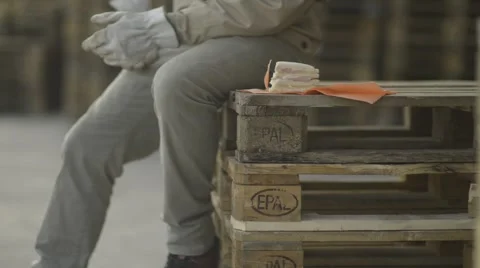 Construction worker sitting on pellets for a lunch break; Full HD Photo JPEG Stock Footage 40758321