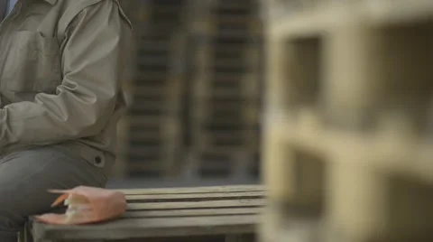 Construction worker sitting on pellets for a lunch break; Full HD Photo JPEG Stock Footage 40758340