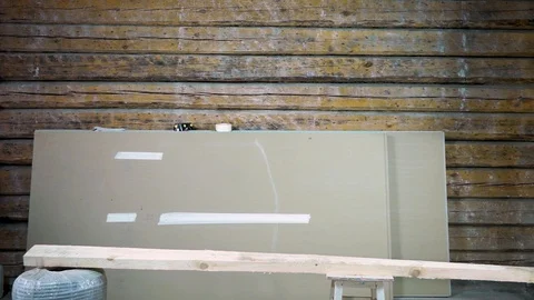 A construction worker is smiling cheerfully at the camera. In his hands he holds Stock Footage 101384343