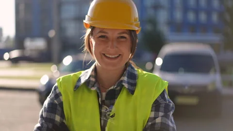Construction worker is smiling on a job site while wearing safety gear Stock Footage 311860886