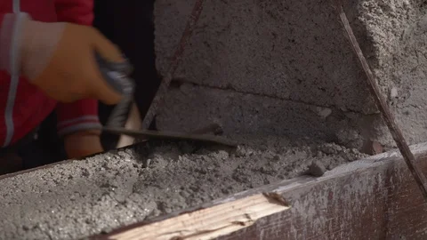 Construction worker smoothes concrete on wall Stock Footage 99872574