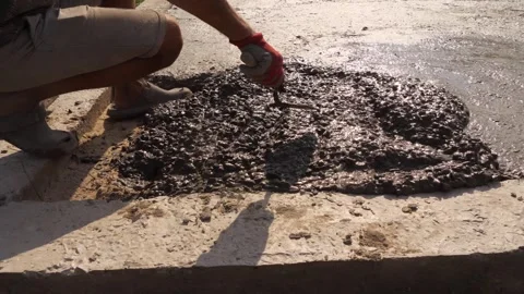 Construction Worker Smoothing Fresh Concrete With Hand Video stock 341786042