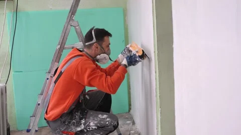 Construction Worker Smoothing Uneven Wall with White Plaster Mixture Stock Footage 320164770
