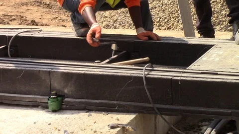 Construction worker spinning a screw on tram rails Stock Footage 116318581