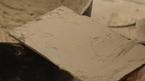 Construction worker spreading adhesive mortar on a tile Stock Footage 346449514