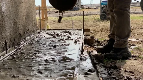 Construction worker spreading cement. Stock Footage 158549640