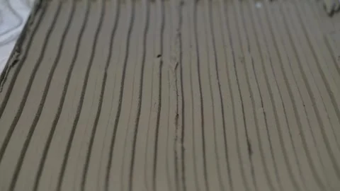 Construction worker spreading concrete or tile glue on the floor. Stock Footage 285390416