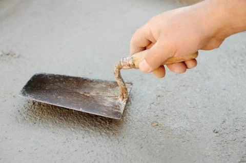 Construction worker spreading wet concrete Stock Photos