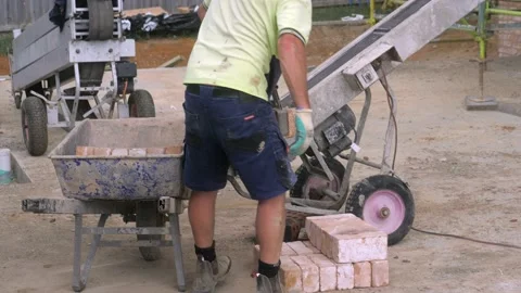 Construction Worker Stacks Rows Of Bricks At New Housing Job Site Stock Footage 166483764