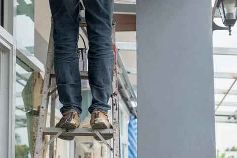 Construction worker standing on aluminium stairs Stock Photos