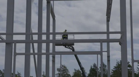 Construction worker standing in a skylift Stock Footage 64550195