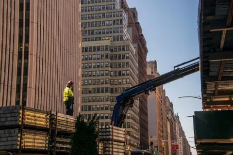 Construction worker standing on top of a concrete load on a large truck on an Stock Photos