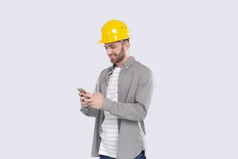 Construction Worker Standing Using Phone Isolated. Man Texting on Phone Stock Photos