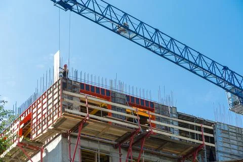 A construction worker stands on the rafters of the upper floor. The builder is 写真素材