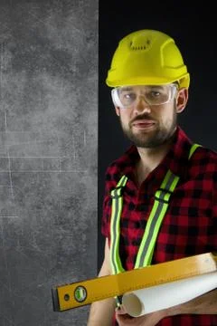 Construction Worker stands by wall. Stock Photos