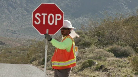 Construction Worker with stop sign Stock Footage 713979