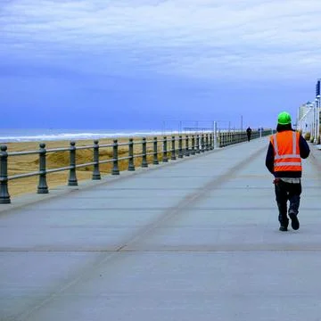 Construction Worker Strolling Down the Boardwalk 写真素材