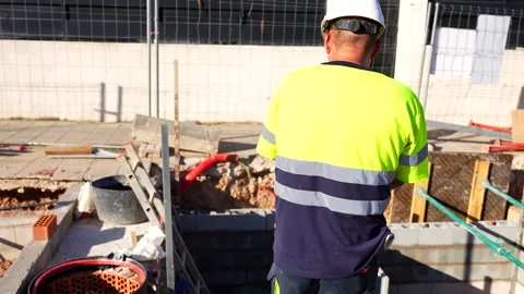 Construction worker supervising a new building project Stock Footage 344564525