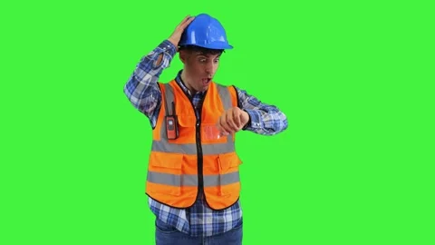 Construction worker surprised while checking his wristwatch, wearing orange.. Stock Footage 286986163
