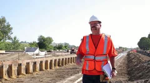 Construction worker surveying irrigation ditch on hot day Stock Footage 11811717