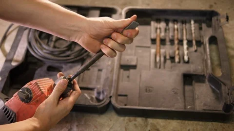 Construction worker swap old wired electrical big rusty Drill bit tools Handyman Stock Footage 126341626
