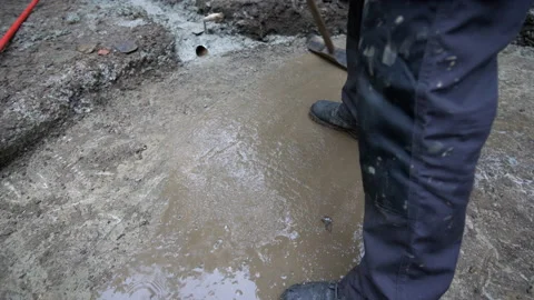 Construction worker sweeping and cleaning concrete foundation Stock Footage 158974423