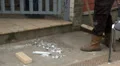 Construction worker sweeping walkway HD Footage