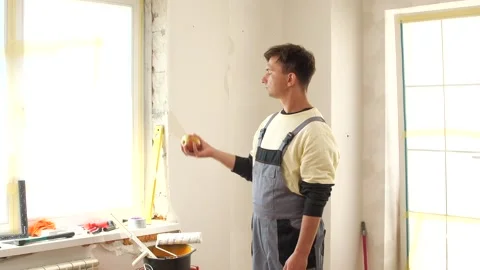 Construction worker taking break eating apple during renovation work Stock Footage 314083007