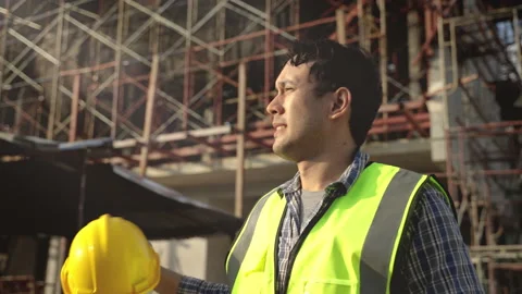 Construction worker is taking off his helmet Stock Footage 231001126