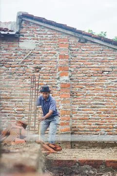 Construction worker taking measurements with white thread for exterior wall c Stock Photos