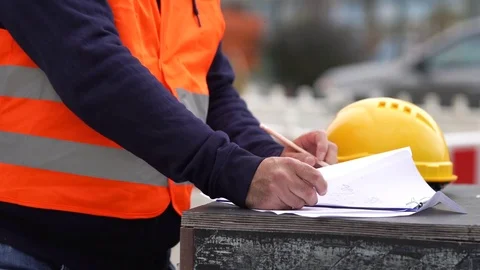 Construction worker taking notes on construction site 스톡 동영상 81033874