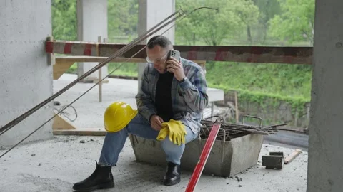 Construction worker taking phone call during break Stock Footage 337466677