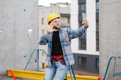 Construction worker taking selfie on building site Stock Photos