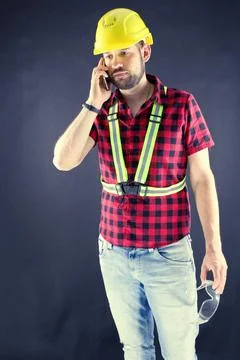 Construction Worker  talking on a cell phone Stock Photos
